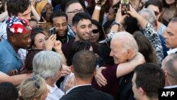 U.S. President Joe Biden greets guests during a celebration for military and veteran families, caregivers, and survivors at the White House, July 4, 2023.
