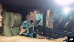 Former Thai Prime Minister Thaksin Shinawatra, center, sits in a vehicle with his daughters Paetongtarn and Pinthongta after being released on parole in Bangkok, Thailand, Feb. 18, 2024.