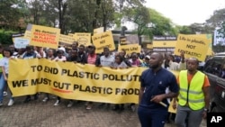 Climate activists carry banners and placards calling for a reduction in global plastic production ahead of the Intergovernmental Negotiating Committee on Plastic Pollution which will take place Nov. 13-19, in Nairobi, Nov. 11, ,2023. 