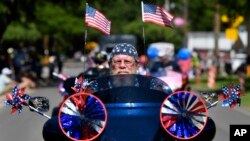 Dwane Tervooren rides with other motorcyclists during Tuesday's Independence Day Parade in Buffalo Gap, Texas, July 4, 2023.