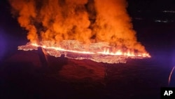 In this photo provided by Civil Protection taken from the Coast Guard's helicopter, a view of lava as the volcano erupts near Grindavík, Iceland, Jan. 14. 2024.