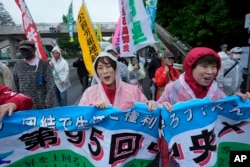 Participants march after a May Day rally in Tokyo, May 1, 2024.
