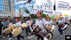 Members of the Korean Confederation of Trade Unions beat their drums during a rally in Seoul, May 1, 2024. Workers, activists and others in Asian capitals took to the streets to mark May Day with protests over rising prices and governments' labor polices.