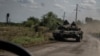 Ukrainian servicemen ride on a tank, as Russia's attacks on Ukraine continue, near the village of Robotyne, Zaporizhzhia region, Ukraine, Aug. 25, 2023.