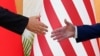 资料片：美国总统拜登与中国国家主席习近平在印度尼西亚巴厘岛20国集团峰会期间举行面对面会谈前伸手握手。（2022年11月14日）