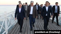 Uzbek, Kazakh and Kyrgyz leaders, Shavkat Mirziyoyev, from left, Kassym-Jomart Tokayev and Sadyr Japarov take a walk by the Issyk-Kul Lake, Cholpon-Ata, Kyrgyzstan, July 20, 2022. 