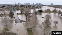 A view of flooding from the rainstorm-swollen Sacramento and American Rivers, near downtown Sacramento, California, Jan. 11, 2023. 