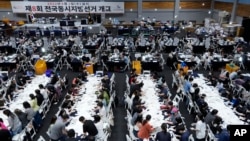 资料照：韩国选举委员会成员在首尔一家体育馆内点数选举市长、州长等官员的地方选举选票。（2022年6月1日）