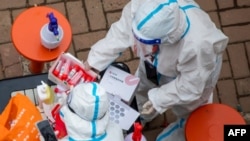 FAAYILII - Hojjattoota magaala Jiliin keessatti qorannoo OVID-19 gochuuf qophiitti jiran, Chaayinaa, Bitootessa 12, 2022