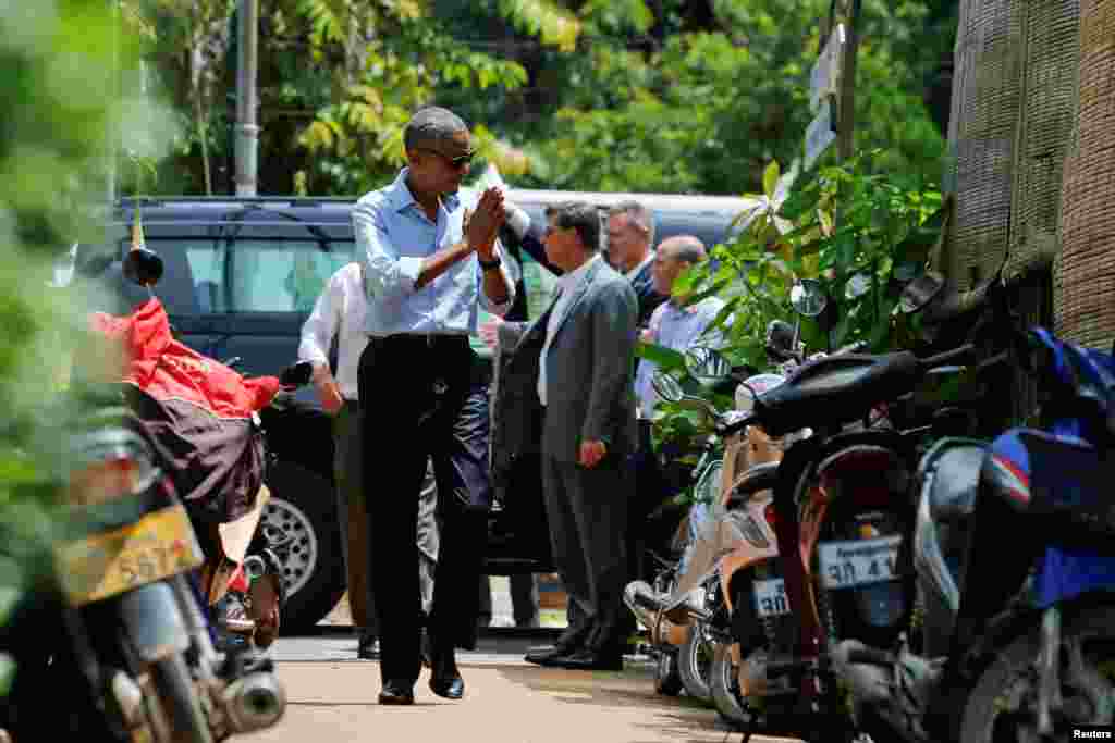 U.S. President Barack Obama greets local residents on a walk in Luang Prabang, Sept. 7, 2016.