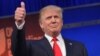 Real estate tycoon Donald Trump flashes the thumbs-up as he arrives on stage for the start of the prime time Republican presidential debate on Aug. 6, 2015 at the Quicken Loans Arena in Cleveland, Ohio.