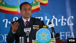 House Speaker Nancy Pelosi looks at small flags placed on the grounds of the National Mall by activists from the COVID Memorial Project to mark the deaths of 200,000 lives lost in the U.S. to COVID-19, in Washington, D.C.