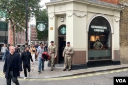 沿途只有便利店、咖啡店和酒吧开门做生意。有军人在附近的星巴克喝咖啡休息 (美国之音/郑乐捷）