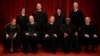 U.S. Chief Justice John Roberts (seated C) leads Justice Ruth Bader Ginsburg (front row, L-R), Justice Anthony Kennedy, Justice Clarence Thomas, Justice Stephen Breyer, Justice Elena Kagan (back row, L-R), Justice Samuel Alito, Justice Sonia Sotomayor, an
