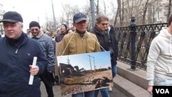 今年3月莫斯科反对俄罗斯吞并克里米亚的大规模群众游行中，示威者手举车臣战争照片，警告俄罗斯在走车臣战争之路。(美国之音白桦 拍摄)