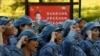 Participants dressed in replica red army uniforms swear an oath during a Communist team-building course extolling the spirit of the Long March in the mountains outside Jinggangshan, Jiangxi province, China, September 14, 2017. 