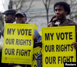 Voting rights activists gather in front of the U.S. Supreme Court in Washington Feb. 27, 2013.