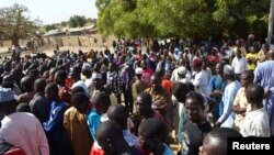 Wasu mutane kennan daga Gwoza, jihar Borno, da tashe-tashen hankula ya raba da gidajensu, suna taro a sansanin ‘yan gudun hijira a lokacin da gwamnan jihar Borno Kashim Shettima (babu hotonshi) a garin Mararaba Madagali, jihar Adamawa. Fabrairu 18, 2014. 