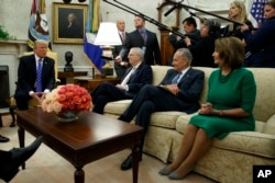 FILE - President Donald Trump speaks to, from left, Senate Majority Leader Mitch McConnell, R-Ky., Senate Minority Leader Chuck Schumer, D-N.Y., and House Minority Leader Nancy Pelosi, D-Calif., during a meeting with Congressional leaders in the Oval Office of the White House, Sept. 6, 2017.