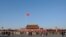 FILE - A Chinese flag flutters against blue sky in Tiananmen Square in Beijing, China, Dec. 24, 2017. 
