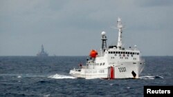 一艘中国巡逻舰在南中国海上行驶，它背后便是饱受争议的石油钻井平台 （资料照）