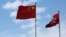 A Chinese national flag and a Hong Kong flag fly outside the Legislative Council in Hong Kong, China November 7, 2016, as China's parliament passed an interpretation of Hong Kong's Basic Law on Monday that says lawmakers must swear allegiance to the city 