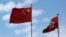 A Chinese national flag and a Hong Kong flag fly outside the Legislative Council in Hong Kong, China November 7, 2016, as China's parliament passed an interpretation of Hong Kong's Basic Law on Monday that says lawmakers must swear allegiance to the city 