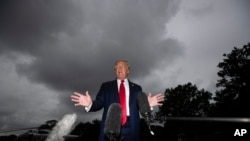 President Donald Trump speaks with reporters before walking to Marine One on the South Lawn of the White House, July 31, 2020, in Washington. Trump is en route to Florida. 