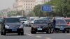 A man waits after being involved in a traffic accident as drivers pass him in heavy traffic on a road in Beijing, China.