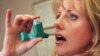 Registered nurse Darlene Martin, from Santa Monica, California, reaches for her asthma inhaler, March 1998. (file photo)