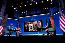 FILE - President-elect Joe Biden and Vice President-elect Kamala Harris participate in a meeting with state officials, at The Queen Theater, Nov. 19, 2020, in Wilmington, Delaware.