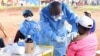 FILE - A Congolese health worker administers Ebola vaccine to a woman who had contact with an Ebola sufferer in the Democratic Republic of Congo, Aug. 18, 2018. Scientists now say they have a treatment for those ill with the deadly virus.