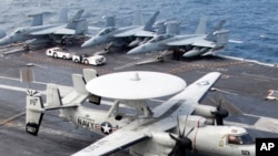 一架E-2C“鹰眼”空中预警机2012年6月24日美韩两国在首尔西南黄海水域举行联合军事演习时候降落在美国航空母舰“乔治.华盛顿”号的甲板上