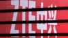 The company logo of ZTE is seen through a wooden fence on a glass door in Beijing, China, April 18, 2013.