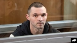 FILE - U.S. Army Staff Sgt. Gordon Black sits in a glass cage in courtroom in Vladivostok, Russia, June 6, 2024. U.S. soldier Gordon Black is on trial in Vladivostok on charges of theft and threatening murder in a dispute with a Russian woman.
