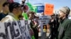 Donald Trump protesters argue with a supporter outside the Holiday Inn Express prior to a scheduled appearance by the Republican presidential candidate in Janesville, Wisconsin, March 29, 2016.
