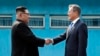 North Korea's leader Kim Jong Un (L) shakes hands with South Korea's President Moon Jae-in (R) at the Military Demarcation Line that divides their countries ahead of their summit at the truce village of Panmunjom