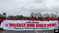In this Monday, May 26, 2014, photo, the Nigerians United Against Terrorism group attends a demonstration calling on the government to rescue the kidnapped girls of the government secondary school in Chibok, in Abuja, Nigeria. Nigeria's defense chief sai