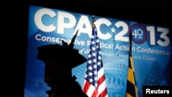 Dressed as a patriot, Tea Party activist William Temple stands for the Pledge of Allegiance at the Conservative Political Action Conference (CPAC) at National Harbor, MD., March 14, 2013. 