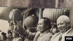Police look at portraits of missing political activists and journalists that protesters pasted on the gate of the Crimean interior ministry in Simferopol, March 18, 2014. 