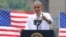 With the Key Bridge, linking Washington and Northern Virginia in the background, President Barack Obama speaks about the economy and transportation at Georgetown Waterfront Park in Washington, July 1, 2014.