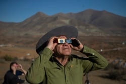 A man looks up at a total solar eclipse in La Higuera, Chile, July 2, 2019.
