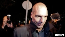 A man arranges "Rakhis" or sacred threads as he waits for customers at his roadside stall ahead of the Hindu festival Raksha Bandhan celebrations, in Kolkata, India.