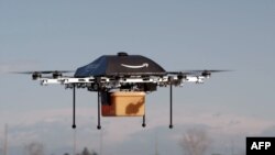 This undated handout photo released by Amazon on December 1, 2013 shows a flying "octocopter" mini-drone that would be used to fly small packages to consumers. Amazon CEO Jeff Bezos revealed on December 1 that his company was looking to the future with pl