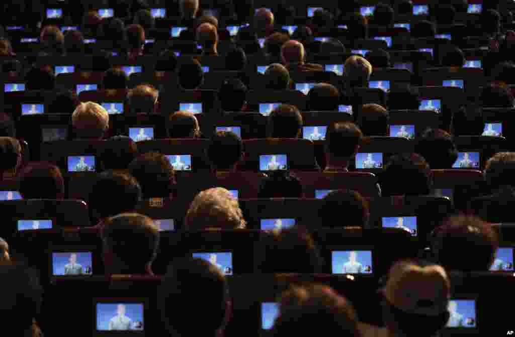 South Korean President Moon Jae-in is seen on small screens as participants listen to his speech during a ceremony to celebrate Korean Liberation Day at Seong Cultural Center in Seoul.