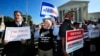 Protesters join others in a rally for fair elections, outside the U.S. Supreme Court in Washington, Oct. 3, 2017.