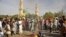 People gather at the site of a bomb explosion in Kano, Nigeria, Friday Nov. 28, 2014. An explosion tore through the central mosque in Nigeria's second-largest city on Friday, and officials feared the casualty toll would be high. Capt. Ikechukwu Eze said t