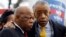 U.S. Rep. John Lewis (L) and the Rev. Al Sharpton confer during a voter's rights rally in front of the U.S. Supreme Court in Washington, Feb. 27, 2013. 