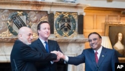 英国首相卡梅伦(中)2月4日主持由阿富汗总统卡尔扎伊(左)与巴基斯坦总统扎尔达里参加的三方会谈