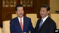 日本公明黨黨魁山口(左)與中共總書記習近平星期五在北京人民大會堂會面